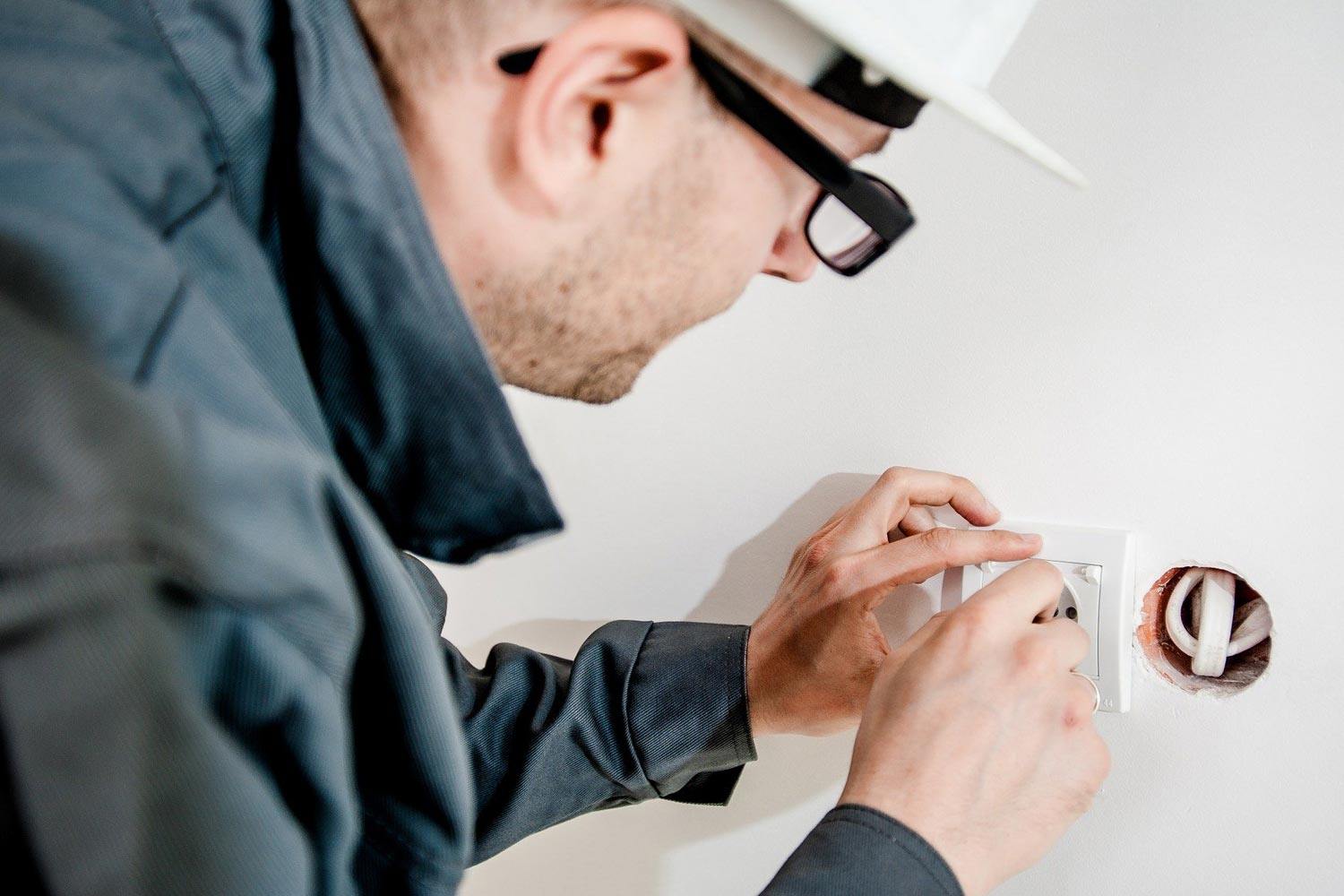 electrician working on pot light installation