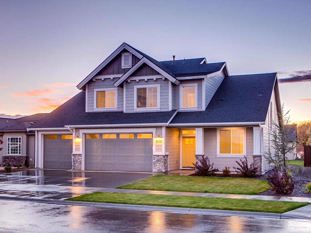 exterior of residential home with bright lights filling the rooms