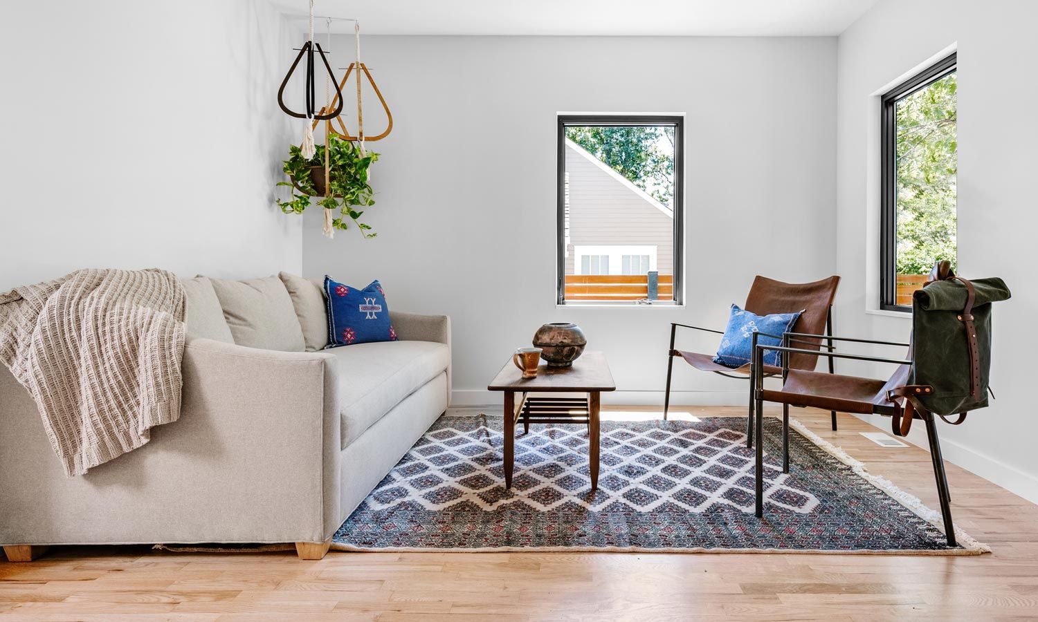 brightly lit living room with blue accents in decor