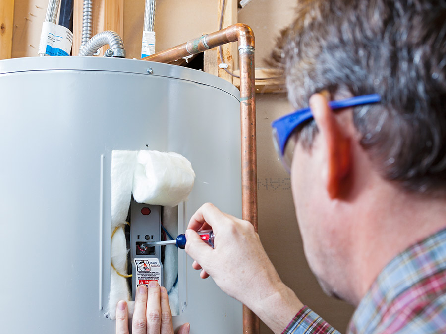 plumber working on water heater