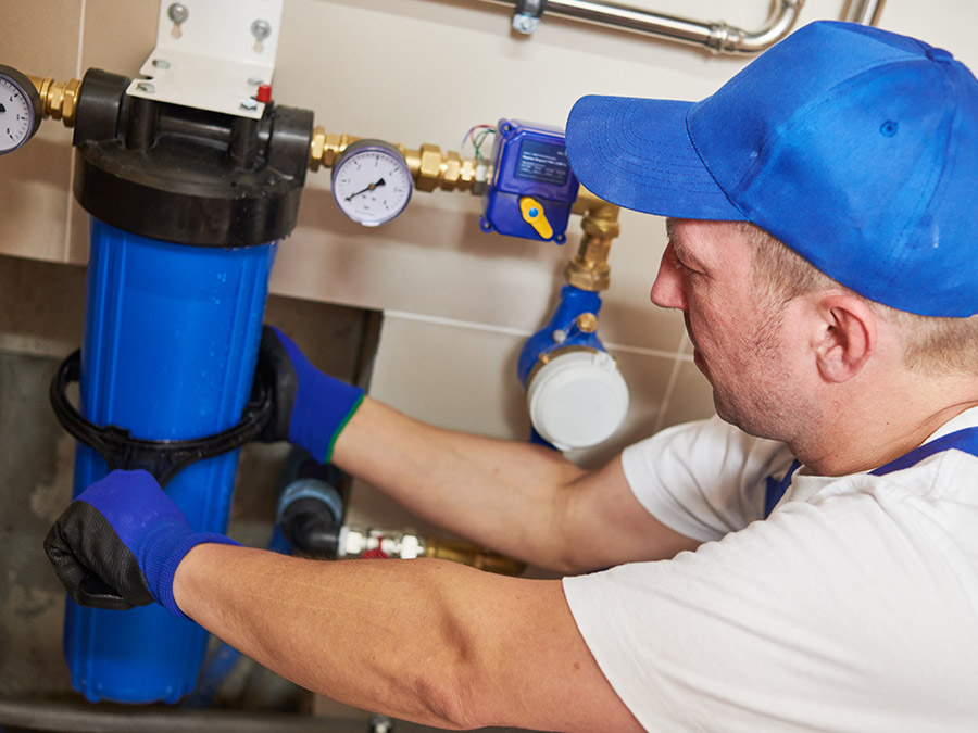 plumber working on water treatment